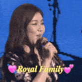 a woman singing into a microphone with the words royal family written below her