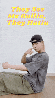 a man sitting on the floor with the words they see me rollin they hatin on the bottom
