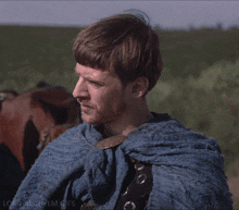 a man is wearing a blue cape with the words lord aldhelm gifs below him