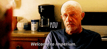 an elderly man sitting in front of a coffee maker says welcome to imperium