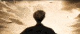 a man is standing in front of a cloudy sky looking at something