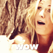 a woman with a surprised look on her face and the word wow on the bottom right