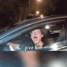 a man in a car with the words give him on the bottom