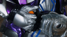 a person in a purple and silver costume holds a gun