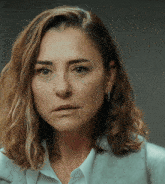 a close up of a woman 's face with a serious expression