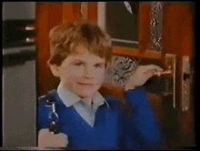 a child drinking from a glass with a premier dairies logo in the background