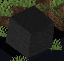 a black block in the middle of a field of grass