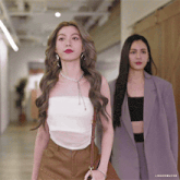 two women are walking down a hallway with the caption lingormgifss at the bottom