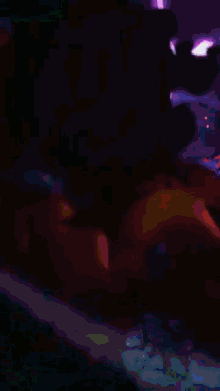 a purple background with a person holding a light