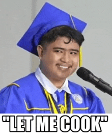 a man in a graduation cap and gown is speaking into a microphone and smiling .