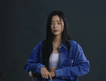a woman in a calvin klein shirt is giving the peace sign