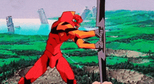 a robot in a red and yellow suit is holding a sword in a field .