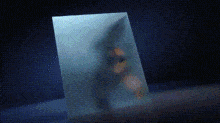 a blurry picture of a person 's face is sitting on a blue table .