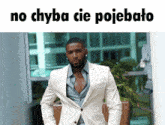 a man in a white suit with the words no chyba cie pojebato