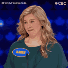 a woman with a name tag that says karen stands in front of a microphone