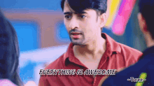 a man in a red shirt with the words everything is awesome written below him