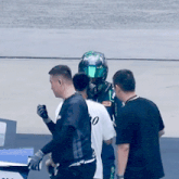 a man wearing a green helmet has a patch on his chest that says ' prize '