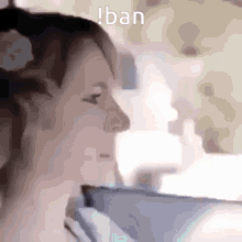 a close up of a woman 's face with the words ban written above her