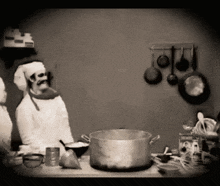 a black and white photo of a skeleton chef in a kitchen with pots and pans