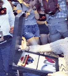 a group of people are gathered around a box that says rock n roll