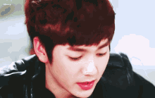 a close up of a young man 's face with the word cherry behind him