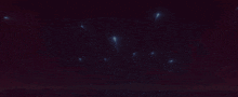 a dark background with a few lights coming out of the bottom