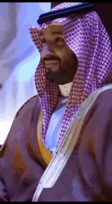 a man with a beard wearing a purple head scarf