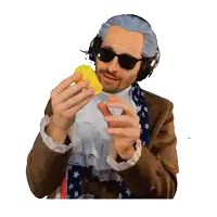 a man wearing a wig and sunglasses is holding a yellow object in his hands
