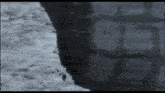 a black and white photo of a person 's shadow on a wall