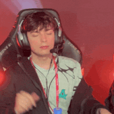 a man wearing headphones and a lanyard that says zone 51 on it