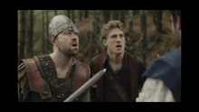 a man wearing a helmet is holding a sword and talking to another man
