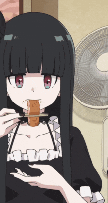 a girl with long black hair is eating a piece of food