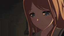 a close up of a girl 's face with her eyes closed in a dark room