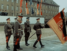 a group of men in military uniforms carrying a flag that says cccp
