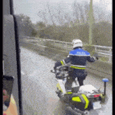 a police officer is riding a motorcycle down a highway