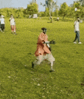 a person with a prosthetic leg is running on a grassy field .