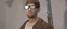 a man wearing sunglasses and a leather jacket holds a gun .