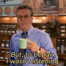 a man in a blue shirt and tie is holding a green mug with the words but to be fair i wasn 't listening