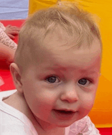 a baby with blue eyes looks at the camera