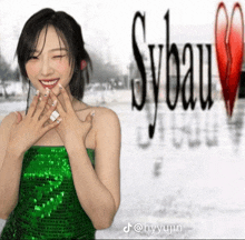 a woman in a green sequined dress stands in front of a sign that says sylvain