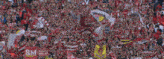 a crowd of people in a stadium with sm written on a red banner