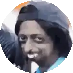 a man wearing a baseball cap and a blue shirt is making a funny face .