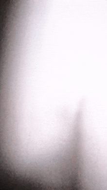a shadow of a person is casting on a white surface .
