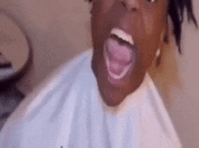 a close up of a person 's face with their mouth open and tongue out .