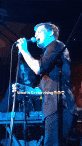 a man singing into a microphone with the words " what is dexter doing " next to him