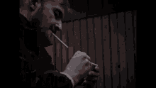 a man lighting a cigarette with a lighter