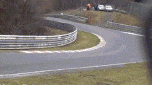 a car is going around a curve in a race track .