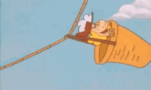 a cartoon character is riding a hot air balloon in the sky .