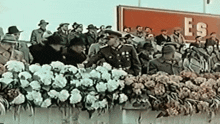 a group of people are standing in front of a sign that says es