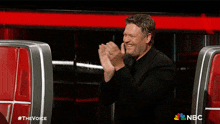 a man applauds during a nbc show